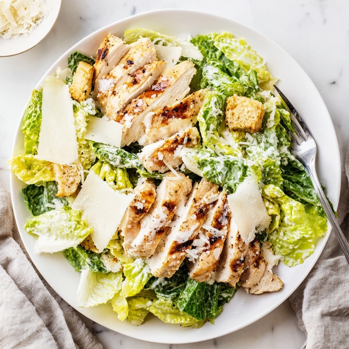 Colorful Chicken Caesar Salad featuring fresh lettuce, flavorful dressing, and grilled chicken slices.