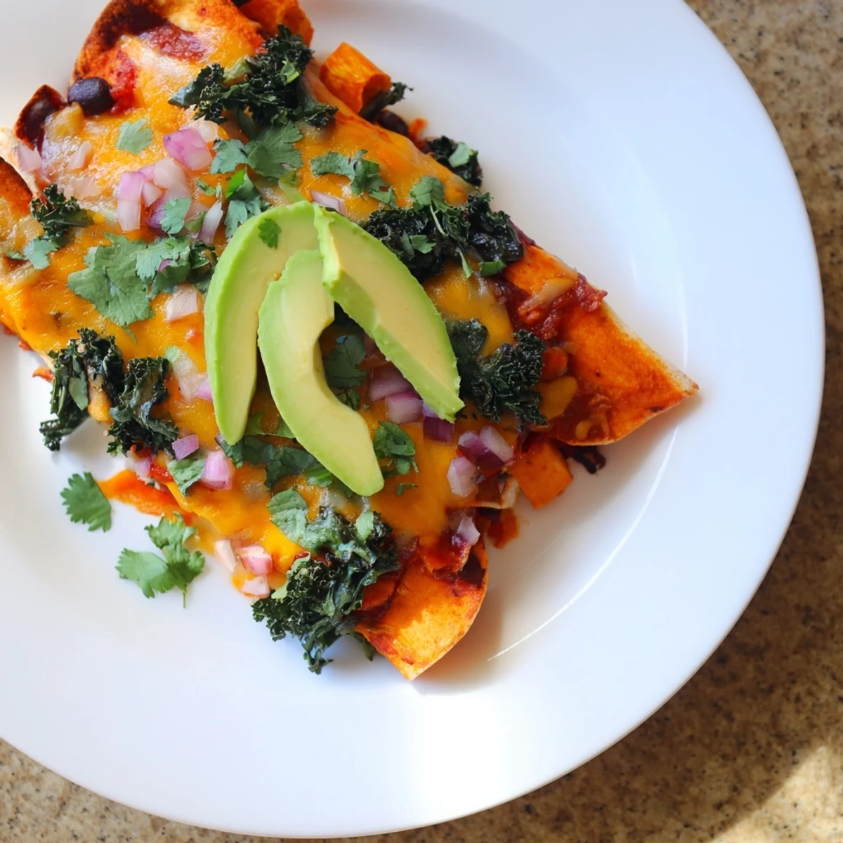 Smoky flavors burst in these vibrant one-pan sweet potato, black bean & kale enchiladas, fresh from the oven.