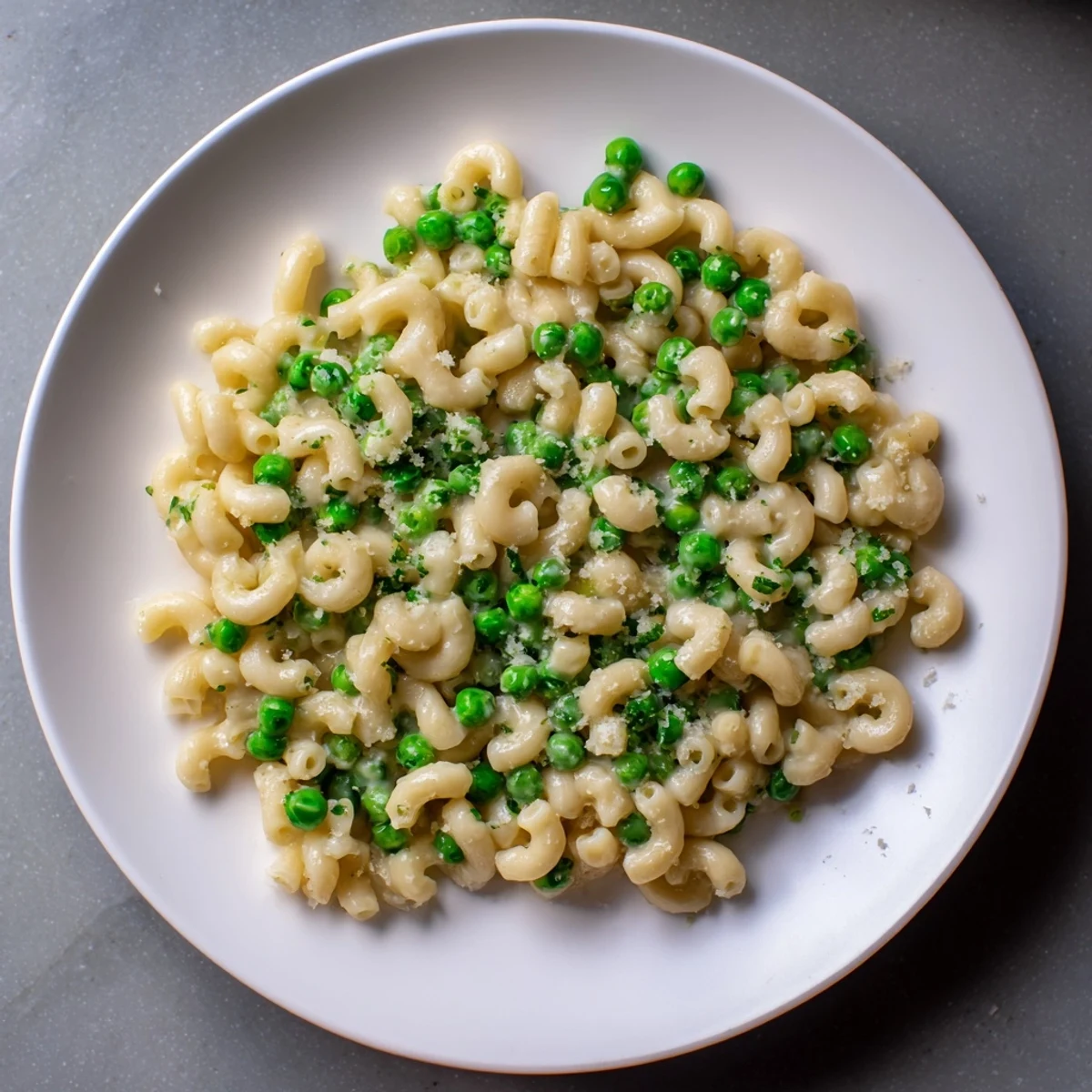 Flavorful Macaroni & Peas, ready to serve with a sprinkle of fresh Parmesan cheese.