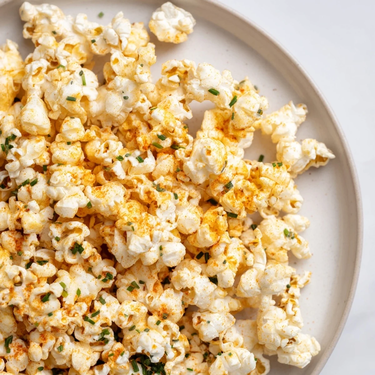 Golden, buttery savoury popcorn mixes tossed with fresh herbs, ideal for game day gatherings.