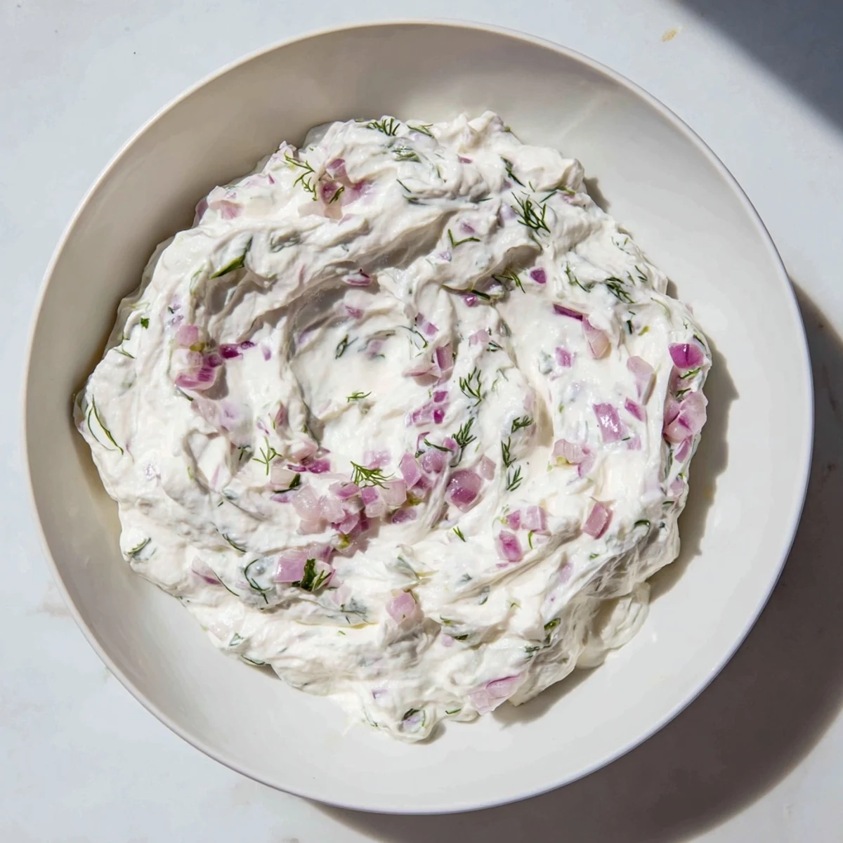 Close-up of a bowl of sweet and sour pickle relish dip, showcasing its cooling freshness.