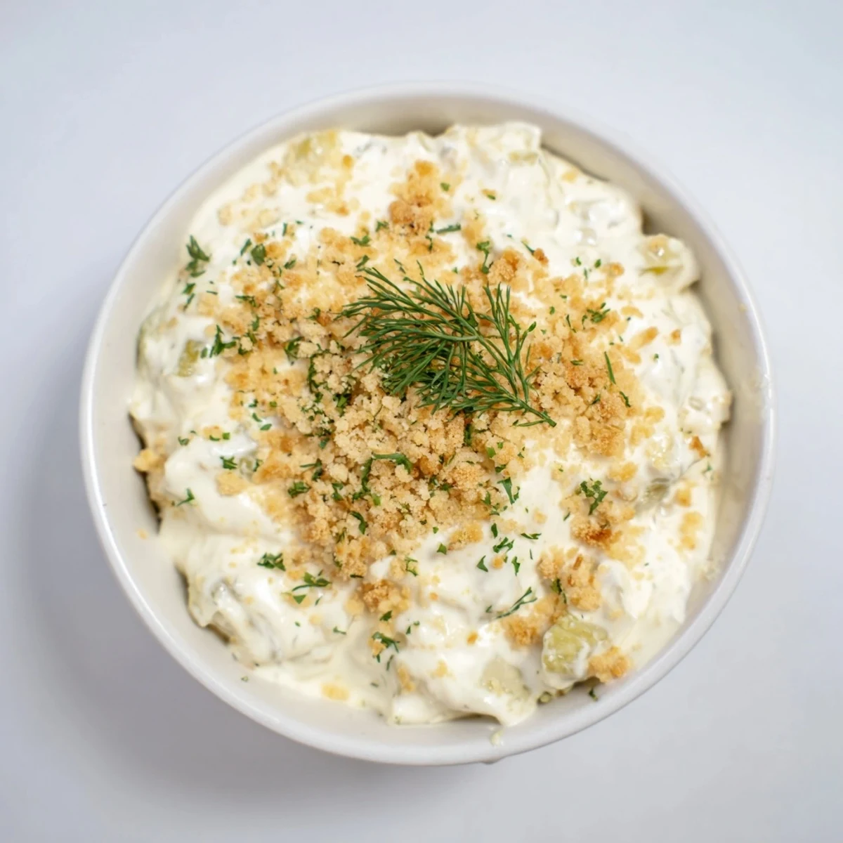 A close-up view of Fried Pickle Dip, garnished fresh dill, perfect for a party appetizer.