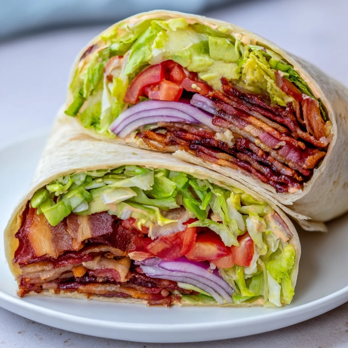 Delicious Zesty BLT Wraps with chipotle mayo filled with colorful veggies and crispy bacon.