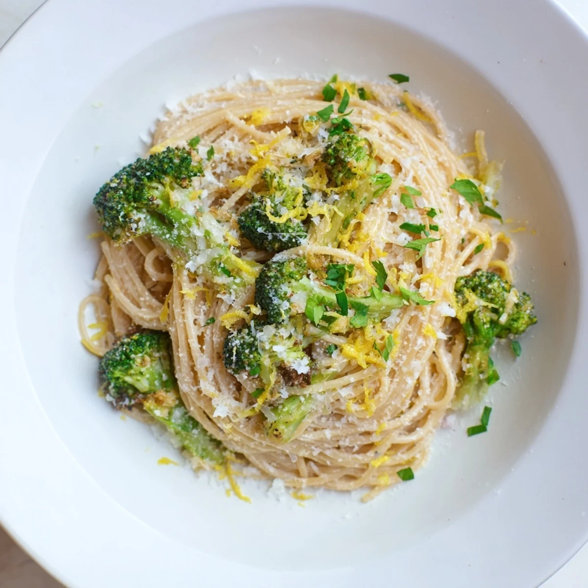 A steaming bowl of Roasted Garlic Lemon Broccoli Angel Hair Pasta, perfect for a cozy weeknight meal.
