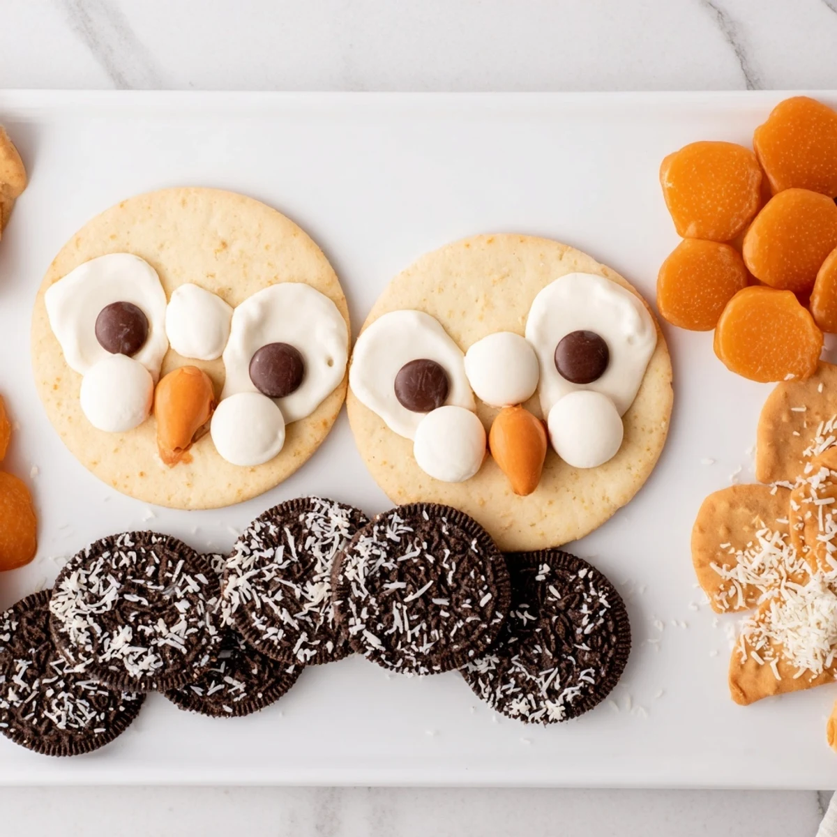 A creatively arranged Owl Hooting Dessert Board with chocolate, cookies, and colorful fruit.
