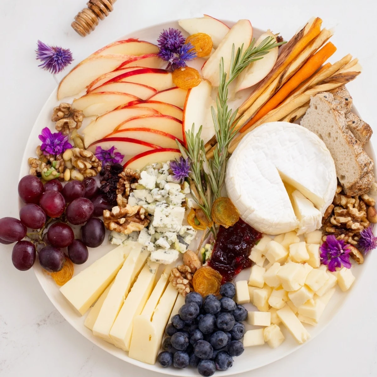 Woodland Creature Cheese Platter with brie, cheddar and grapes, ready to enjoy at a gathering.