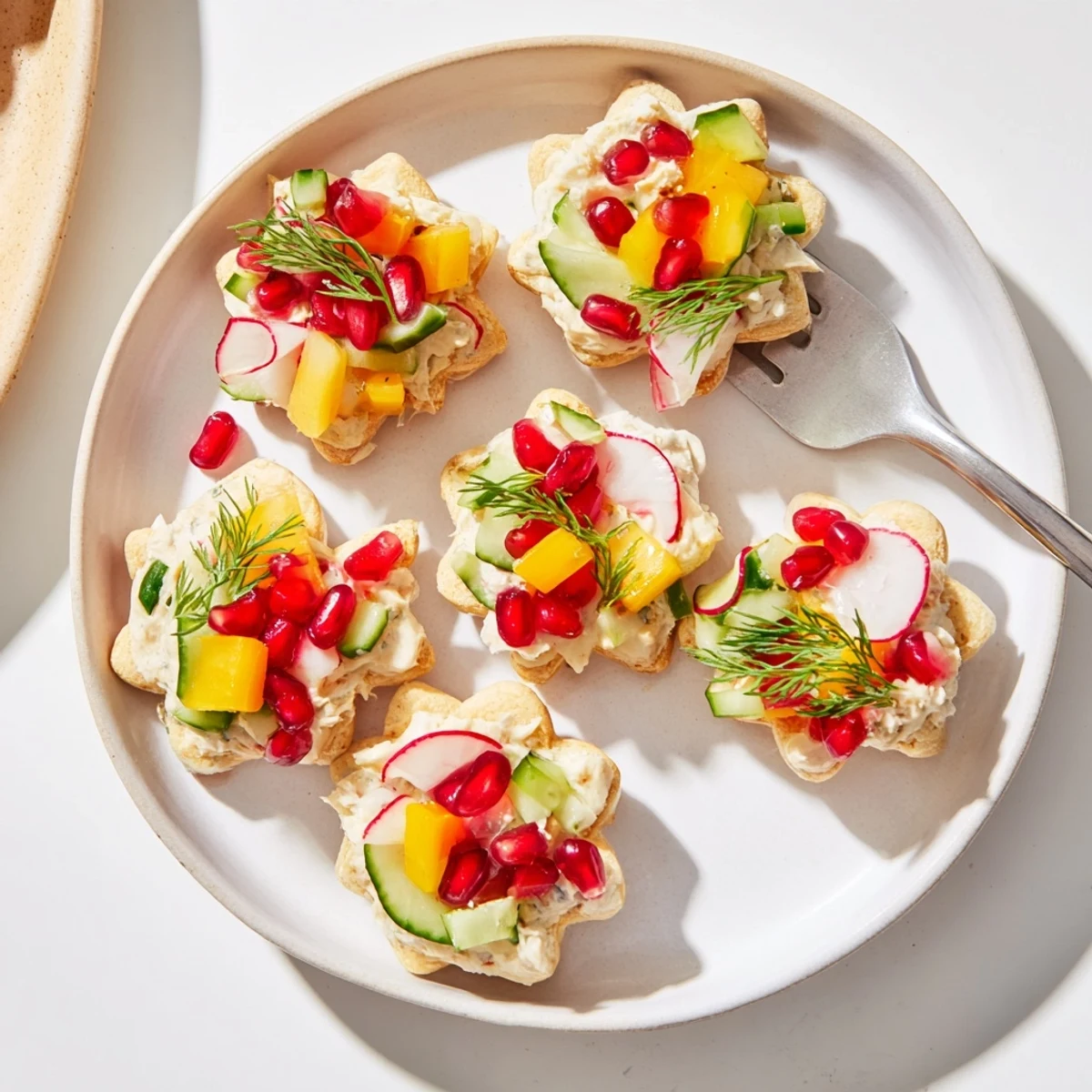 Ornament Shaped Cracker Toppings: Vibrant, festive crackers adorned with colorful peppers, fresh herbs, and creamy cheese spreads.