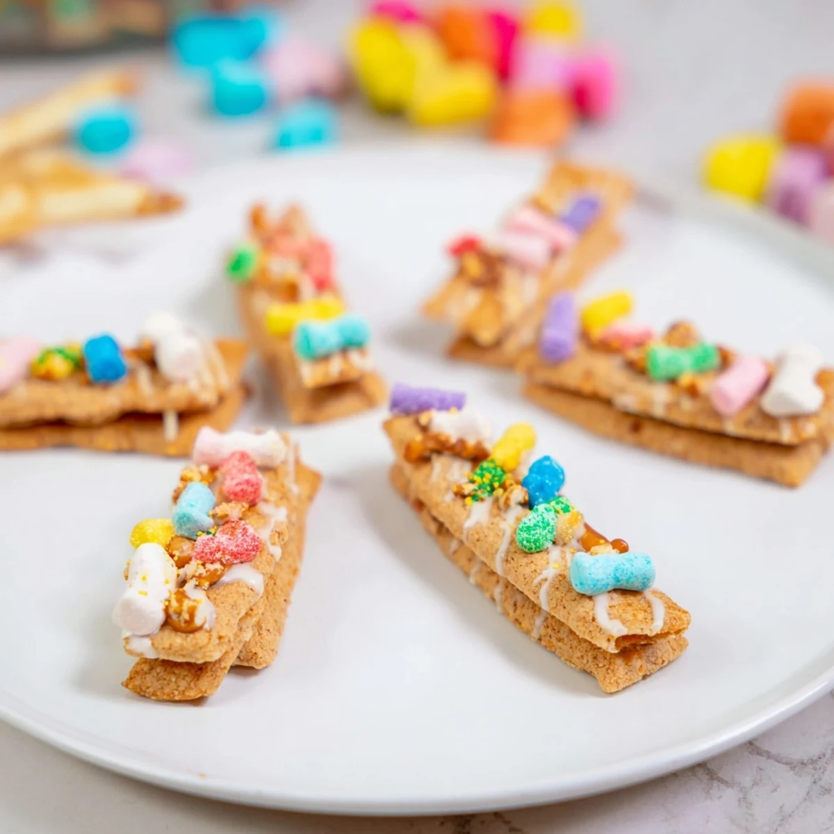 Vibrant Candy Land gingerbread path dessert board featuring gummy candies, sprinkles, and dipping sauces everyone will enjoy.