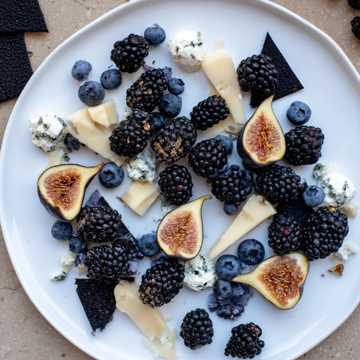 This Deep Indigo Midnight Sky cheese board features dark fruits, creamy cheese, and black rice crackers ready to serve.