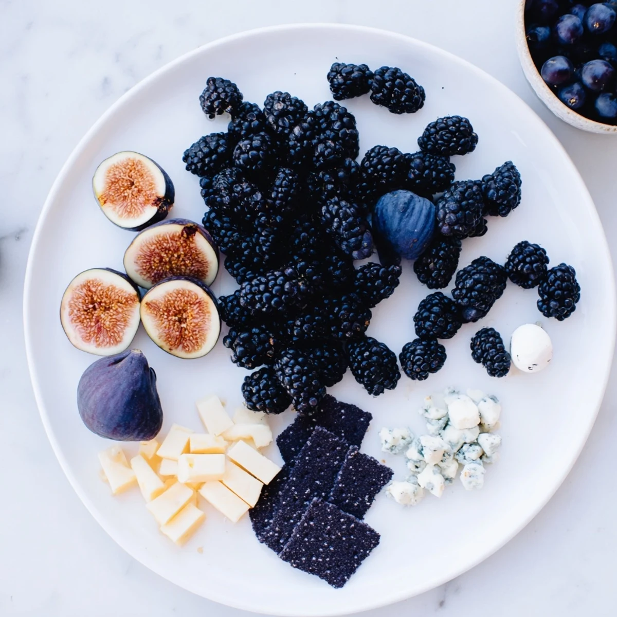 Imagine a vibrant Deep Indigo Midnight Sky cheese board, full of tasty and beautiful appetizer ingredients.