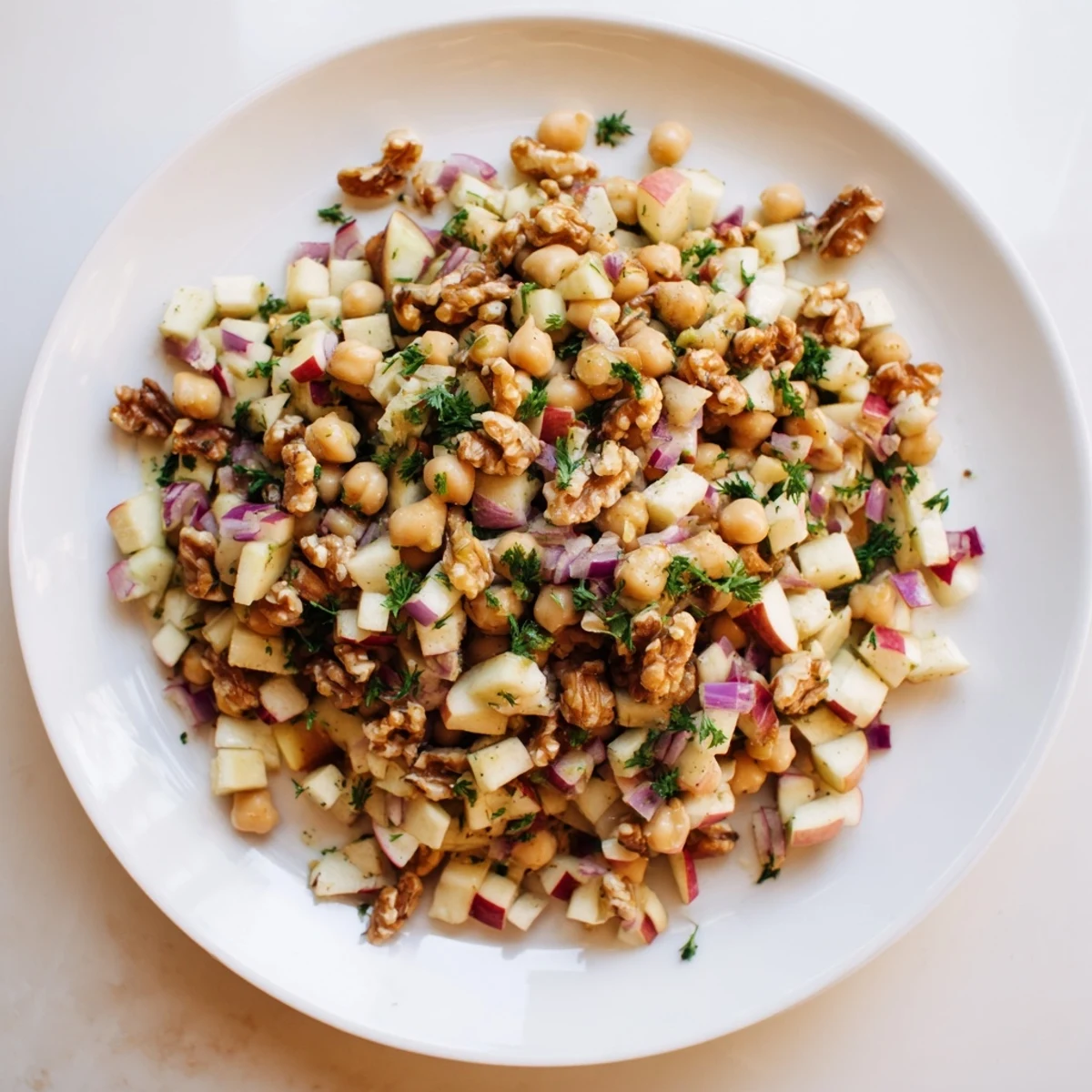 Fresh Fall Harvest Apple and Chickpea Salad bursting with vibrant colors, ready to eat.