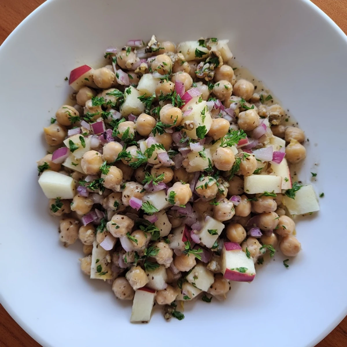 A close-up of Fall Harvest Apple and Chickpea Salad, showing apple slices and creamy chickpeas.