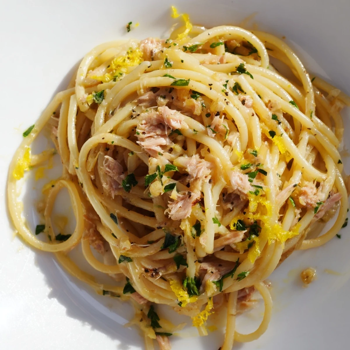 Steaming Lemon-Garlic Tuna Spaghetti, a flavorful pasta dish with flaky tuna and lemon zest.
