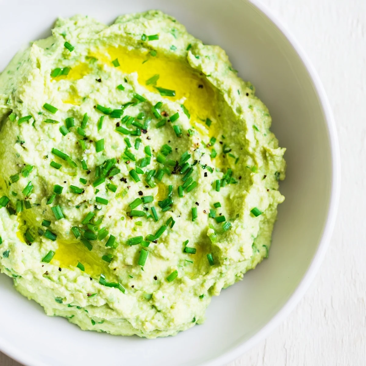 Green, vibrant Avocado Cottage Cheese Dip, blended until silky smooth, ready to enjoy with crackers.