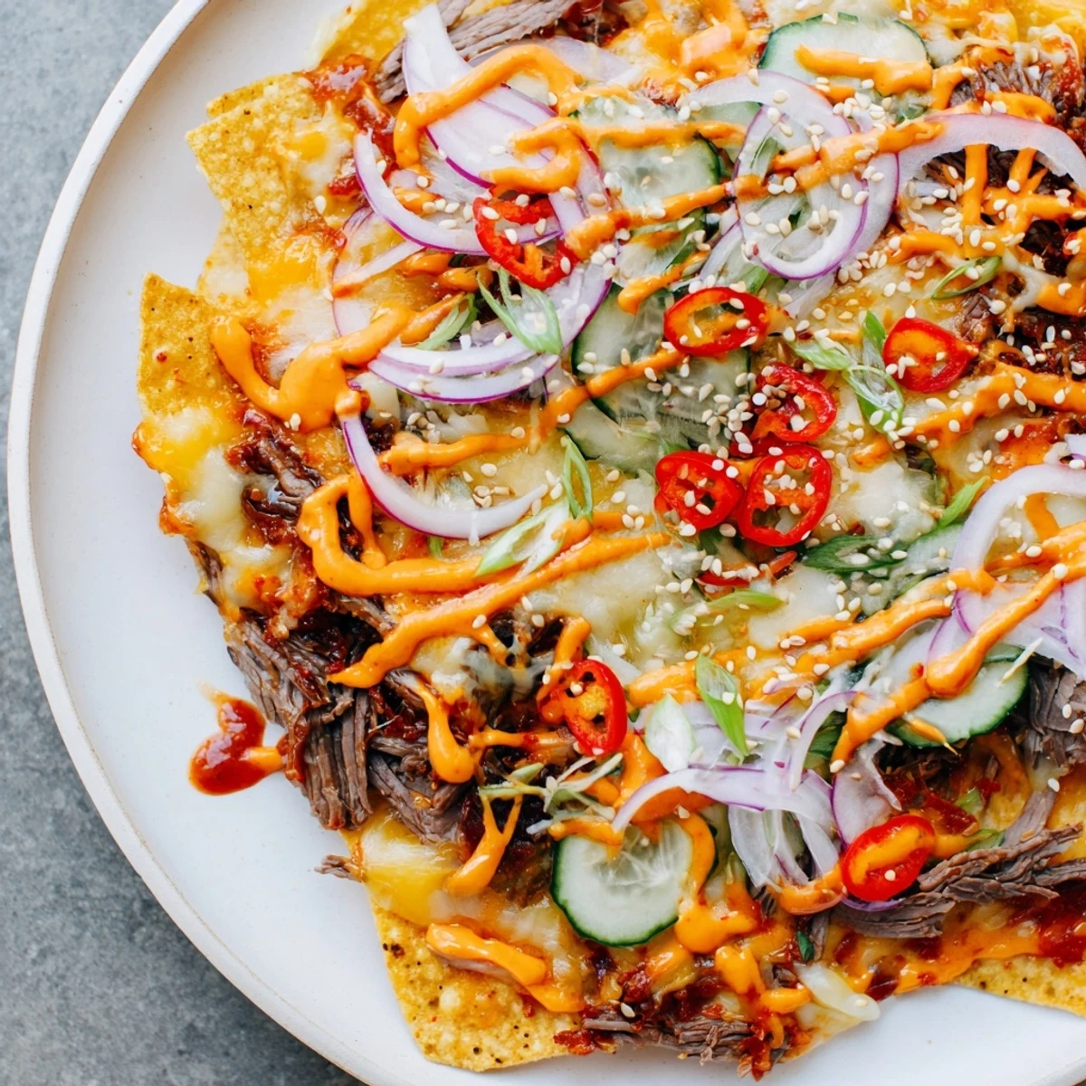Melted cheese and savory gochujang beef star in this delicious Korean BBQ Nachos recipe.