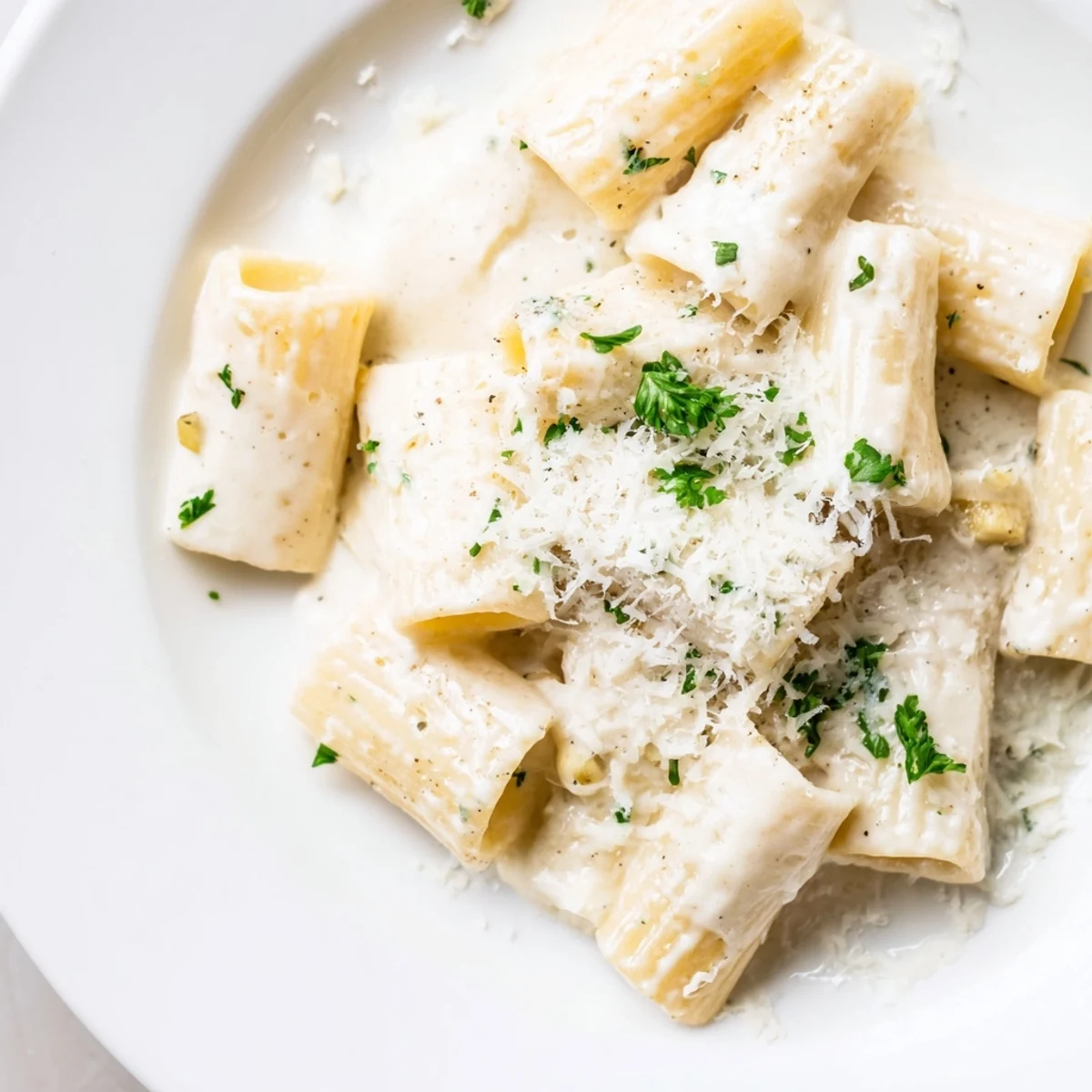 Fork twirling penne pasta coated in silky, milk-based sauce from the Creamy Milk Pasta One-Pot, garnished with Parmesan and black pepper.