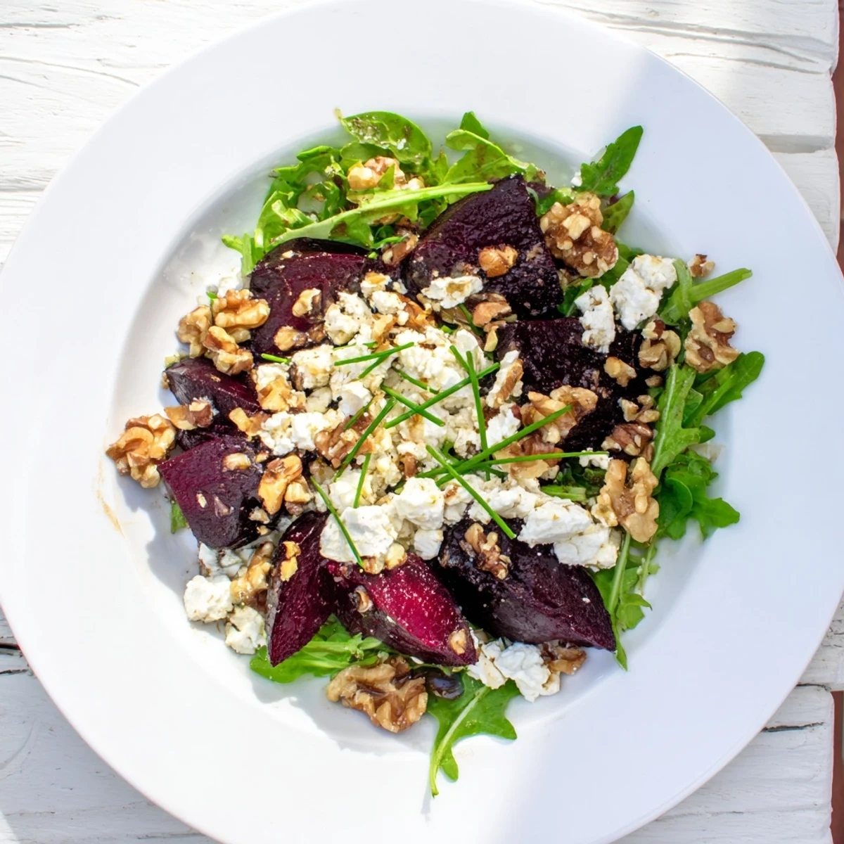 Warm roasted beet goat cheese salad with fresh arugula and walnuts, drizzled in balsamic vinaigrette for a zesty finish.