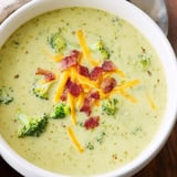 A steaming bowl of Broccoli Cheddar Soup, paired with golden toasted buttered bread for dipping.