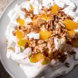 A close-up of vibrant Elevated Ambrosia Salad, perfect for a summer dessert, layered with fruit and cream.