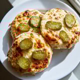 Crispy edges of a warm pickle bread sandwich with cheese, perfect for a quick lunch or snack.