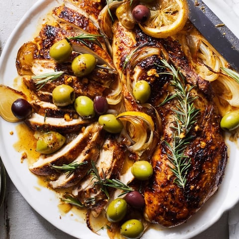 Juicy Rosemary Garlic Roasted Chicken with Olives, ready for a comforting Mediterranean dinner.