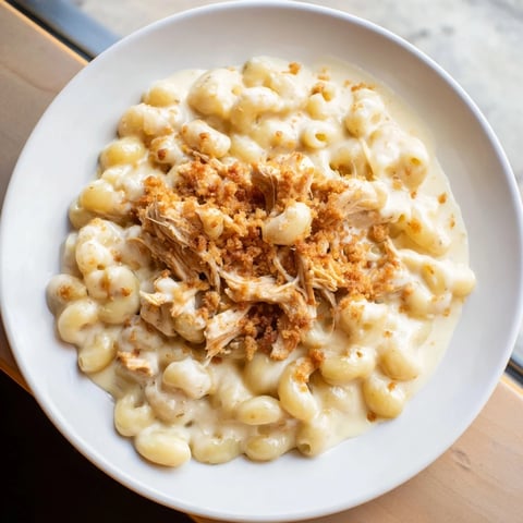 Creamy mac and cheese with BBQ chicken, golden-baked, perfect for a cozy family dinner.