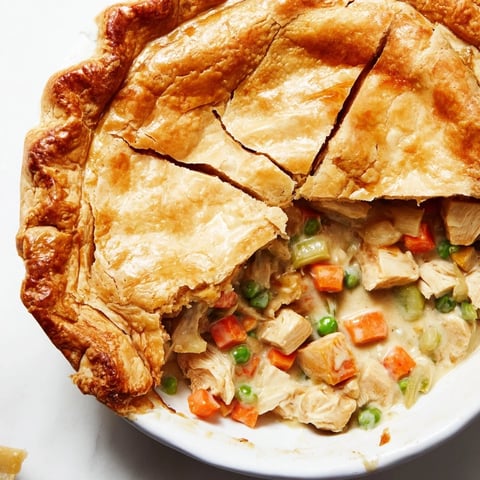 Marry Me Chicken Pot Pie with a golden, flaky crust, overflowing with creamy chicken and vegetables.
