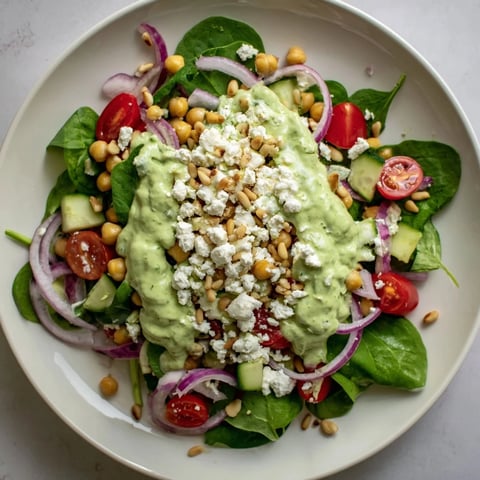 Vibrant Pesto Chickpea and Spinach Salad, bursting with fresh flavors and drizzled with creamy homemade pesto.