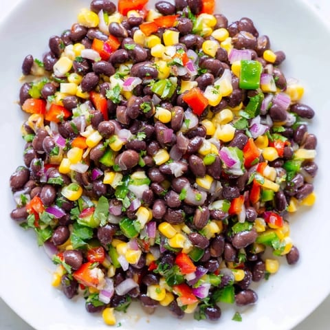 Vibrant Cowboy Caviar Salad with colorful peppers and a zesty lime dressing, ready to eat!
