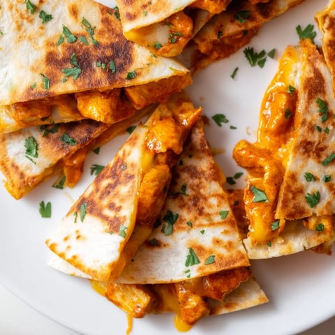 Golden-brown Butter Chicken Quesadillas, a delightful fusion of Indian flavors and Mexican comfort food.