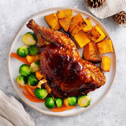 Tender Sheet-Pan Roasted Turkey Breast, surrounded by caramelized winter vegetables with a bright glaze.