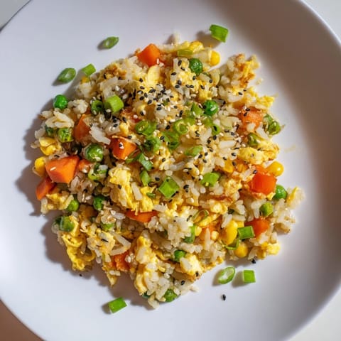 A close-up of savory frozen veggie fried rice, showcasing perfectly cooked rice and a glistening soy sauce glaze.
