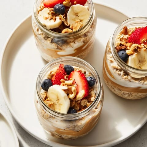 A close-up shot of colorful overnight oats jars boasting fresh fruit and peanut butter swirls.