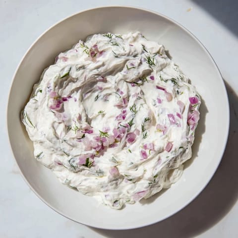 Close-up of a bowl of sweet and sour pickle relish dip, showcasing its cooling freshness.