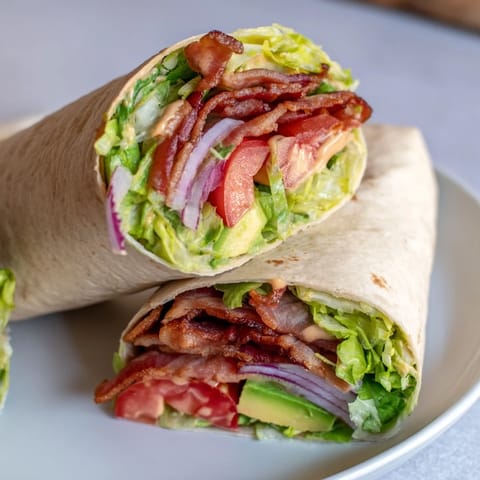 Fresh Zesty BLT Wraps, with a creamy chipotle sauce and vibrant tomatoes, are ready to enjoy now.