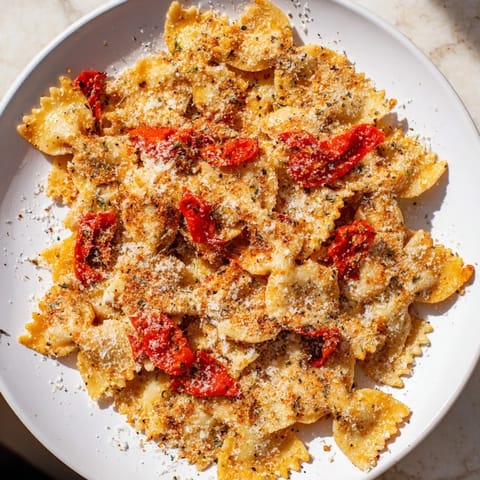 Close-up of baked Lightened Christmas Pasta Chips, a festive snack with roasted red pepper garnish.
