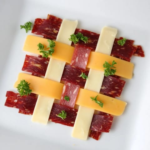 Beautiful, close-up view of The Tartan Plaid, a savory appetizer with layered jerky and cheese.