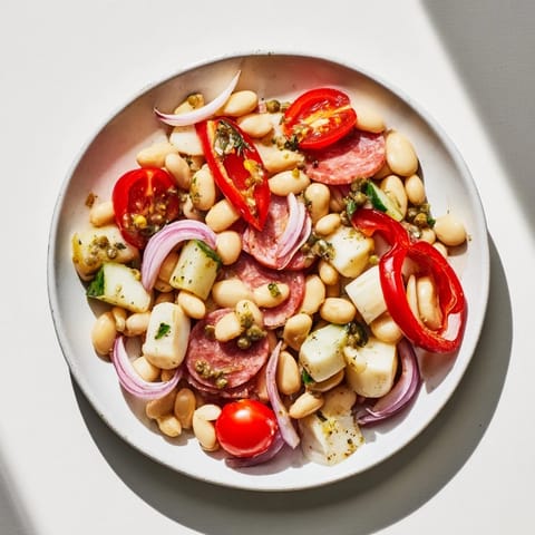 This Italian Antipasto Bean Salad features a refreshing mix of flavors and textures, with hearty beans and olives.