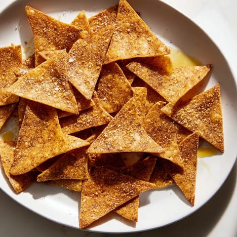 View a close-up of freshly made air-fryer tortilla chips ready for snacking, light and flavorful.