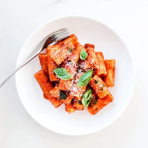 A vibrant bowl of Hidden Veggie Tomato Pasta Sauce ready to toss with penne, highlighting its rich color and comforting aroma.  