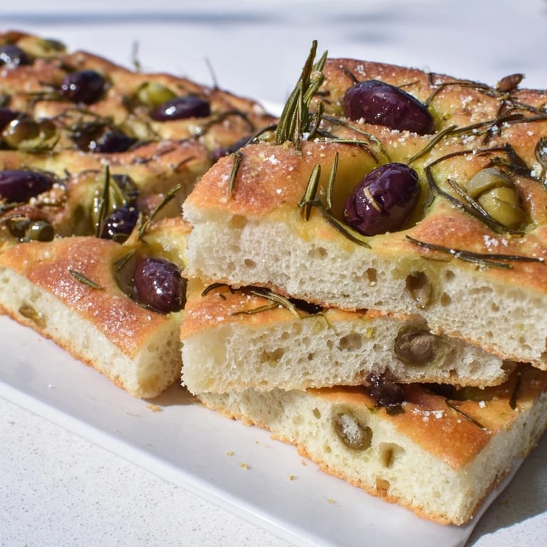 Aromatic Rustic Olive Oil Focaccia Bread, lightly drizzled with olive oil and spices.  