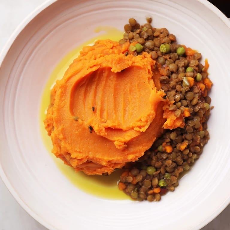 This hearty Veggie Shepherd's Pie features a rich lentil filling beneath a fluffy sweet potato topping.