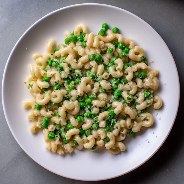 Flavorful Macaroni & Peas, ready to serve with a sprinkle of fresh Parmesan cheese.