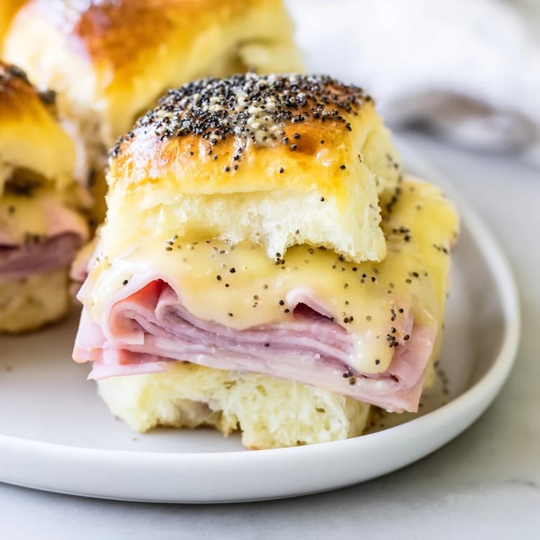 Enjoy the aroma of warm, buttery Baked Ham and Cheese Party Sliders: a perfect, shareable appetizer or meal.