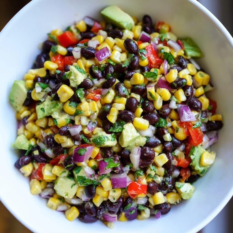 A bright bowl of Southwestern Black Bean and Corn Salad, ready to enjoy with a zesty lime-cilantro dressing.