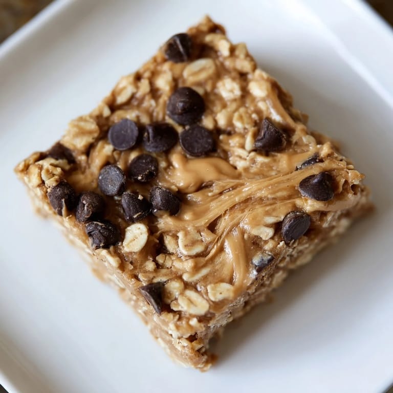 Freshly cut, no-bake Peanut Butter Banana Oat Bars, offering a sweet peanut butter and banana flavor.