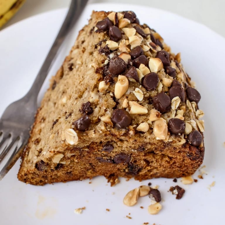 This wholesome Chocolate Chip Peanut Butter Oatmeal Banana Bread has a golden crust and soft interior, perfect for breakfast or afternoon snacking.