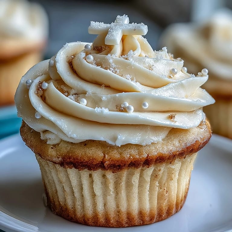 Soft vanilla cupcakes decorated with smooth buttercream and delicate fondant crosses, perfect for religious milestone gatherings.