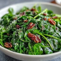 A vibrant arugula salad with tangy lemon vinaigrette and delicate Parmesan shavings, perfect for a light lunch or appetizer.
